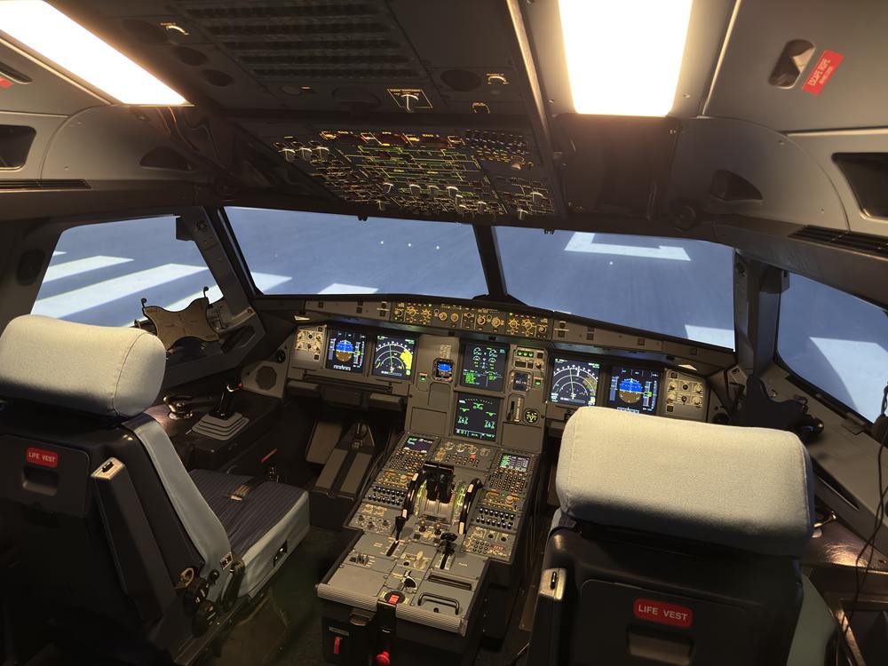Blick ins hell beleuchtete Airbus-Cockpit des Full Flight Simulators